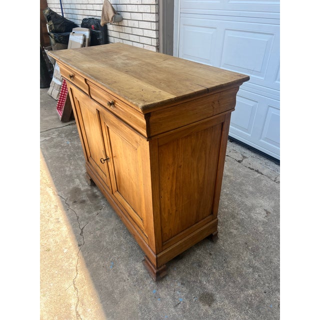 Beautiful 19th-century Louis Philippe buffet handcrafted from solid walnut, showcasing clean lines and a warm natural...