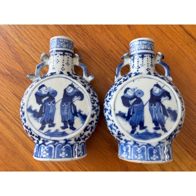 Add classic Chinoiserie charm to your home decor with this lovely pair of hand-painted Chinese blue and white porcelain...