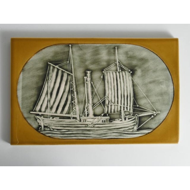 A mid-century stoneware art plaque or wall tile entitled "Stockholmshäxan", designed by Britt-Louise Sundell for the...
