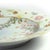 This striking, decorative plate is made of fine porcelain. It is decorated with hand-painted floral ornamentation,...
