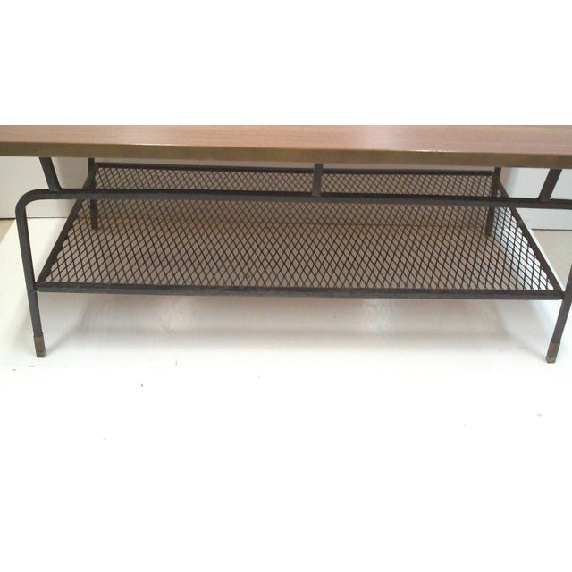 Arthur Umanoff iron mesh coffee table with walnut laminate top. This heavy duty rectangular iron table has an iron mesh...