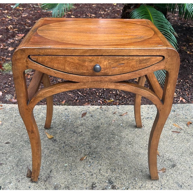 Walnut end table with interesting lines and detail by Uttermost. Uttermost furniture is top of the line and available to...