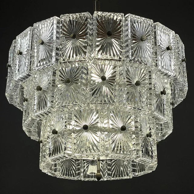 Unique vintage large crystal chandelier made in Italy in the 1960s. Three-tier metal base and 45 glass elements. The...