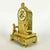 This gilt-bronze table clock dating to the early 19th century is a charming French Empire pendulum clock. Its arched case...