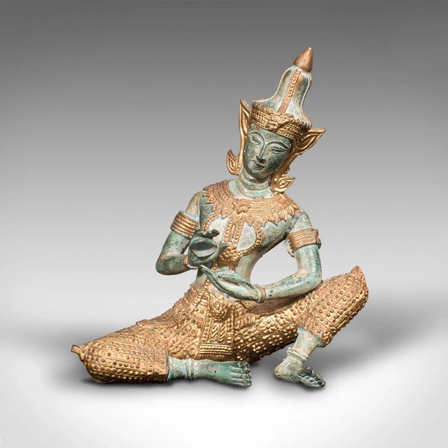 This is a vintage decorative figure. An Oriental, gilt bronze statue Thai deity, dating to the late Art Deco period, circa...