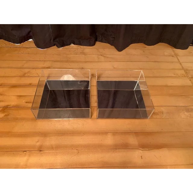 A pair of 1970s lucite mirror shelves. In original and good condition. Attractive design and variety of applications.