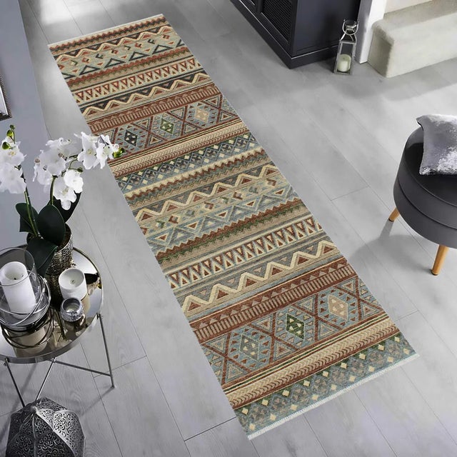 Designed with a mesmerizing intricate transitional and geometric motif this glorious hand-knotted rug made with handspun...