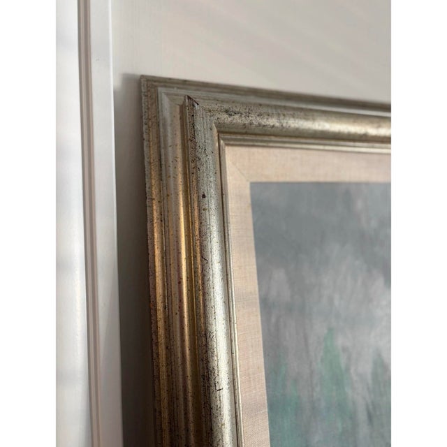 Offered is a vintage framed landscape painting with soft pastel colors and a silver frame. This piece was from the estate...