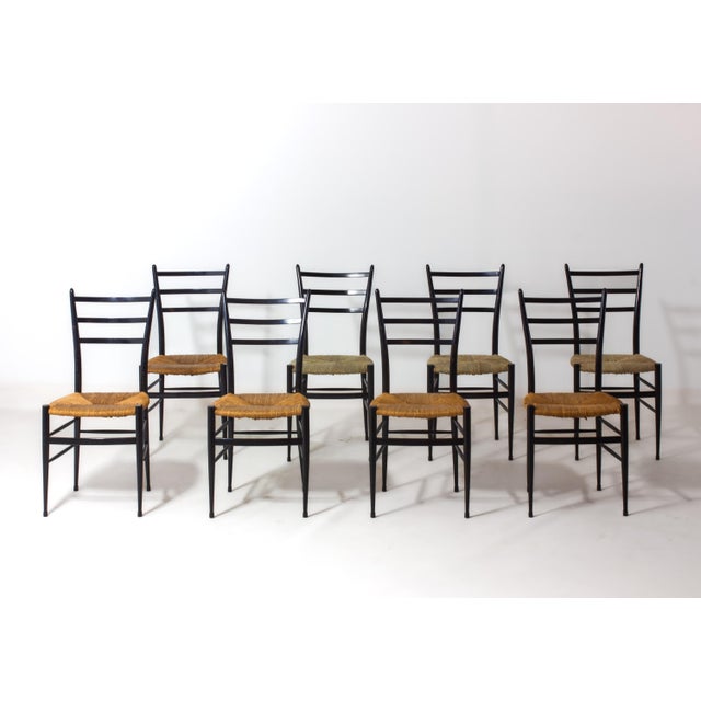 Set of 8 vintage Italian “Spinetto” dining chairs by Chiavari, crafted in Italy during the 1950s–1960s. Each chair is...