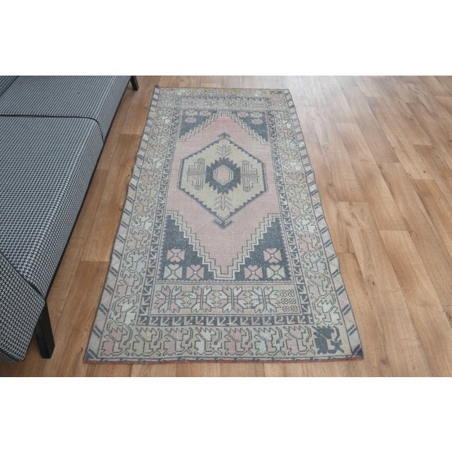 Vintage Hand-Knotted runner rug is a semi-antique vintage area rug. The '70s Eastern region of Anatolia's unique rug is...