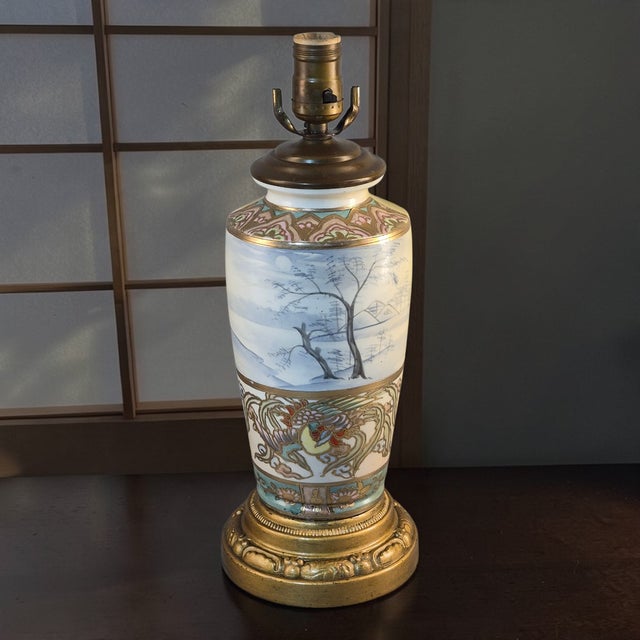 The Antique Nippon Scenic Moriage Hand Painted Table Lamp is a stunning piece originating from Japan in the late 19th...