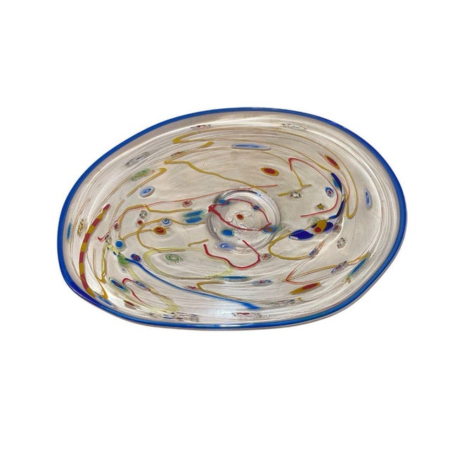 A vibrant and playful handmade millefiori glass plate by Ursa Major (France), dating to the 1970's, embellished with...