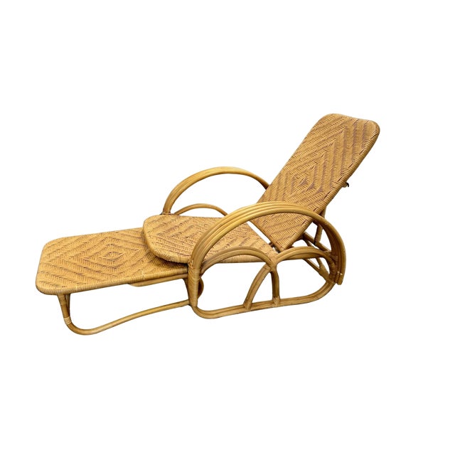 This is a beautiful, authentic vintage reclining lounge chair crafted from warm toned bamboo and a durable woven rattan...