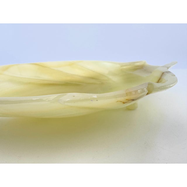 A sculptural vintage leaf-form tray hand carved from richly translucent alabaster stone. Measuring 12 inches long, the...