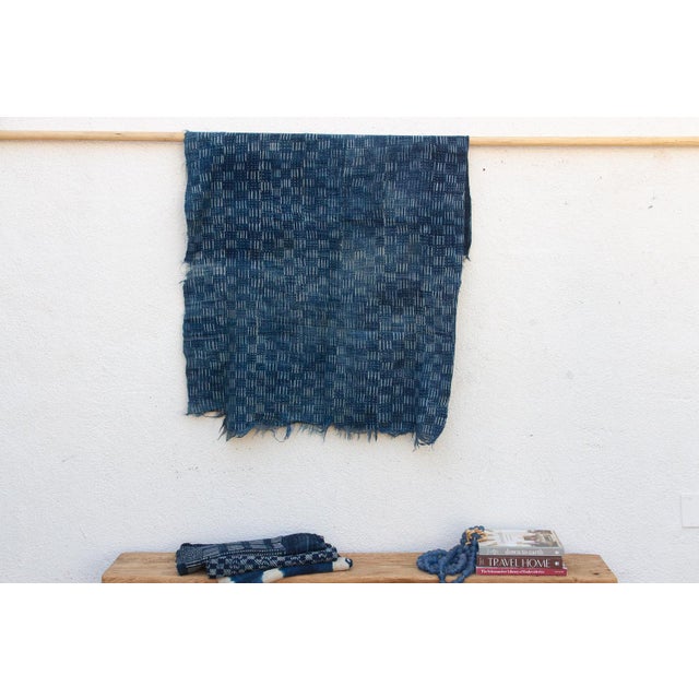 A masterwork of Malian textile heritage featuring deep indigo saturation and symbolic geometric motifs. Originating from...
