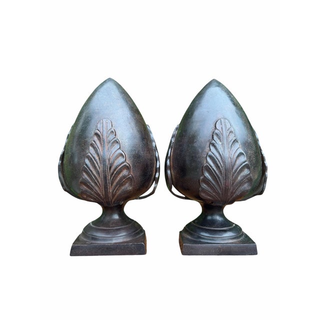 A striking pair of vintage cast metal artichoke form architectural finials featuring finely carved leaf detailing and rich...