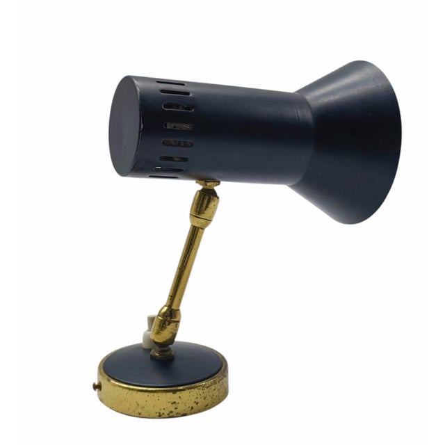 Wall Lamp by Stilnovo in Brass and Black Metal. The lamp features a cantilevered structure supported by a finely finished...