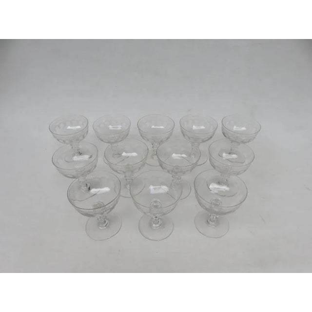 Exceptional set of 12 champagne glasses from the 19th century from France The cup has a round circular pantographiertes...