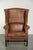 This large and luxurious sheepskin wingback chair features a beautiful, warm cognac color and a stunning patina. It is...