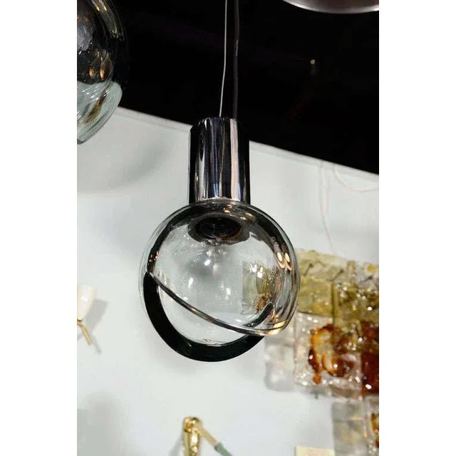 A 1960s handblown grey glass globe and chrome mount pendant light produced by the famed Seguso glass house in Murano,...