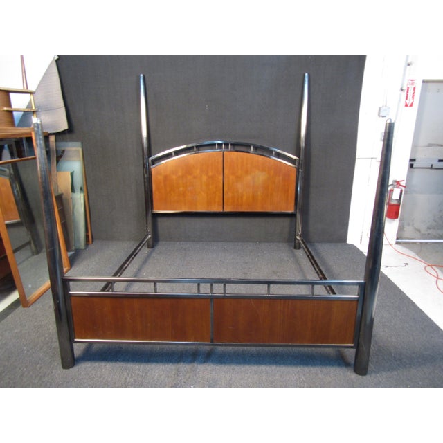 This impressive bed frame set by Mastercraft features tall bedposts and contrasting materials for a unique Mid-Century...