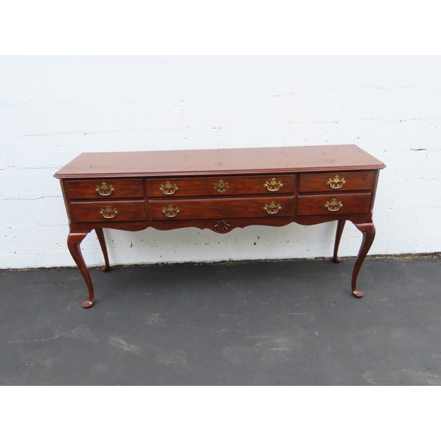 This Console Table is made of wood, solid wood, cherry, veneer, and metal. The Console was made by Drexel, and it is...