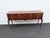 This Console Table is made of wood, solid wood, cherry, veneer, and metal. The Console was made by Drexel, and it is...