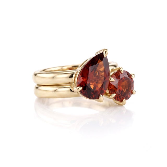 Make an unforgettable statement with the deep crimson intensity of natural red garnet. Arranged in a symbolic two-stone...