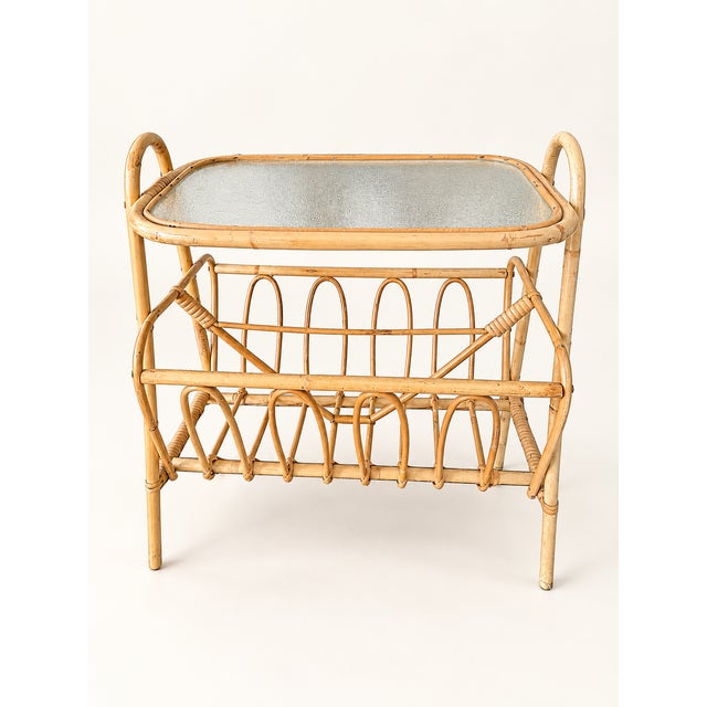 Elegant vintage Scandinavian rattan magazine rack and side table, dating from approximately the 1960s. This charming Mid-...