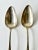 A pair of early 19th century coin silver spoons. Each features a long and deep bowl with curved handle which is monogramed...
