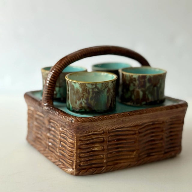 Wicker weave majolica ceramic basket with 4 footed egg cups. The color combination is turquoise and blue with a touch of...