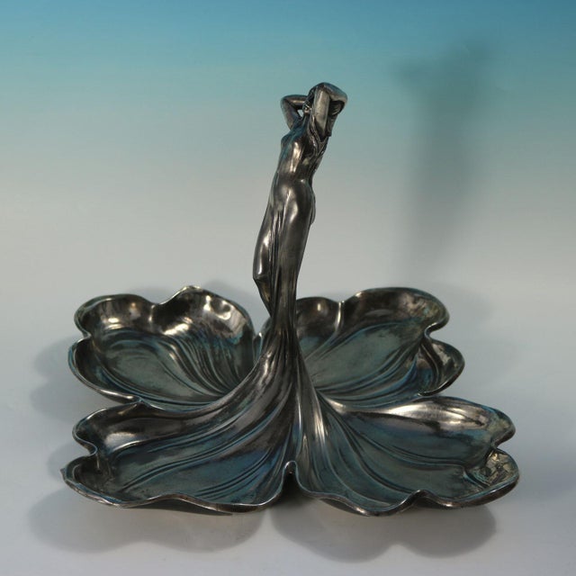 WMF fruit or sweet dish in the form of a sensuous maiden in the center of four shaped dishes which are formed by the skirt...