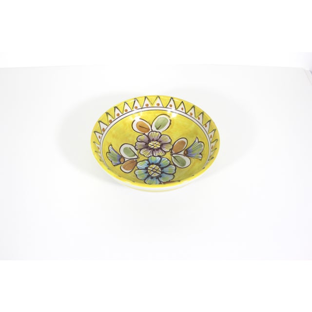This is a vintage handmade, hand painted ceramic pottery bowl in bright lemon yellow with orange, green, blue and purple....