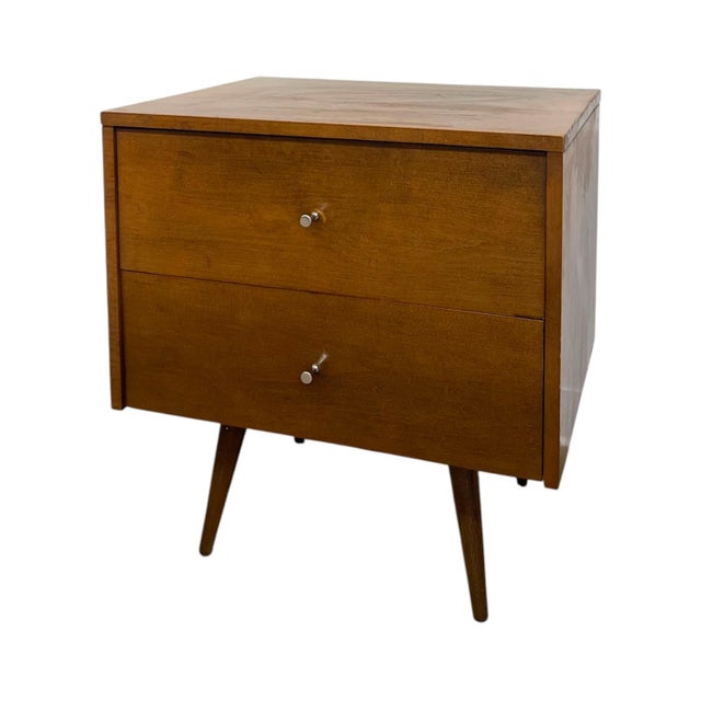 This authentic 1950s mid-century modern two-drawer nightstand is an iconic minimalist design from Paul McCobb’s legendary...