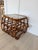 Vintage bent rattan side table featuring a smoked glass top and an airy curved frame. Its timeless design complements...