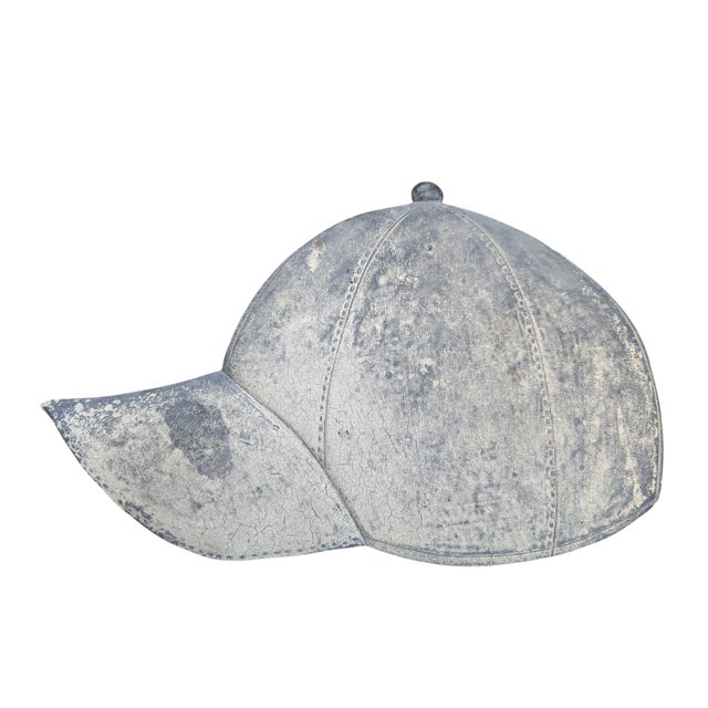 Vintage Late 20th Century Trompe L'oeil Hat made to look like a weathered Ball Cap Lays Flat on a Shelf, a stack of coffee...