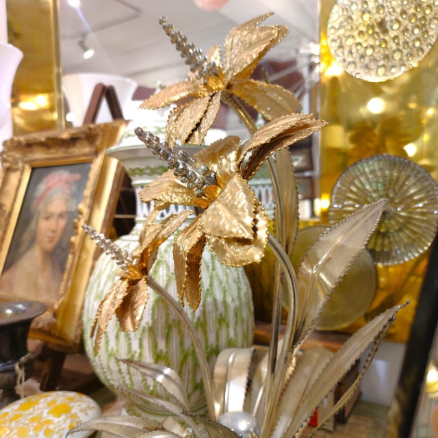 French table lamp made of partially blued brass. It alludes to the designs of Maison Jansen. It is shaped like three lily-...