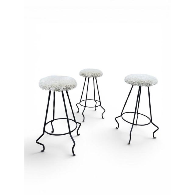 Specifications This trio of kitchen island stools features a striking combination of textured wool upholstery and...