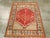 A vintage Turkish Anatolian throw rug. From the Bergama area in northwest Turkey, a coral red field displays a vigorous...