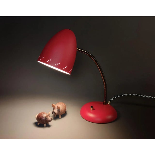 An original vintage mid-century desk lamp with a flexible gooseneck stem and an attractive pierced shade, lacquered in a...
