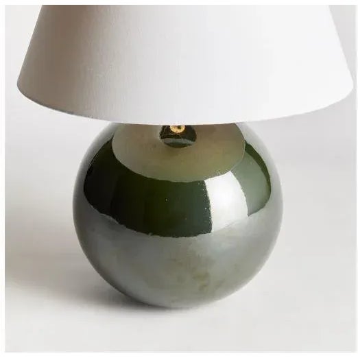 With a perfectly rounded ceramic body and a rich green high gloss glaze, this lamp adds a pop of color to any setting....