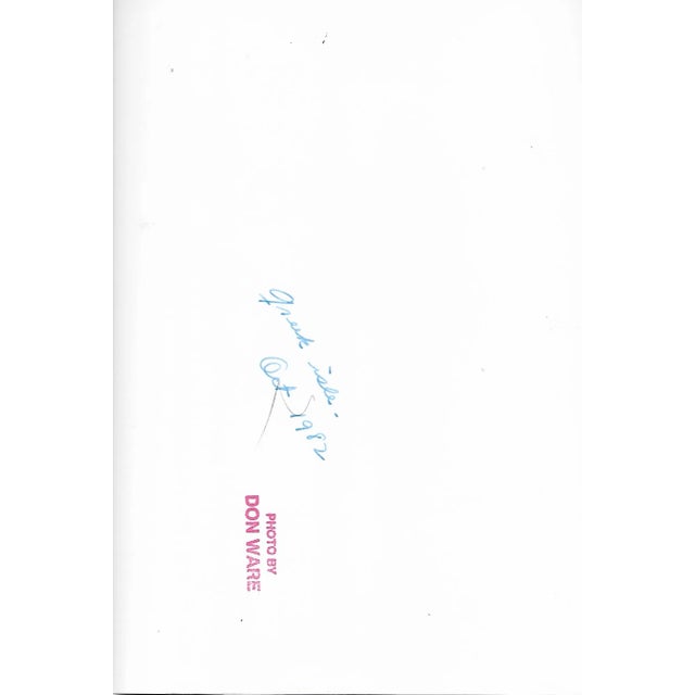 1971 black and white photo by Los Angeles, California by Don Ware of boats tied up along a town market on an island in...