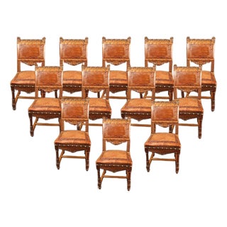 Set of 12 Antique Italian Renaissance Style Hand-Carved Walnut Dining Chairs With Embossed Leather, Circa 1890 For Sale