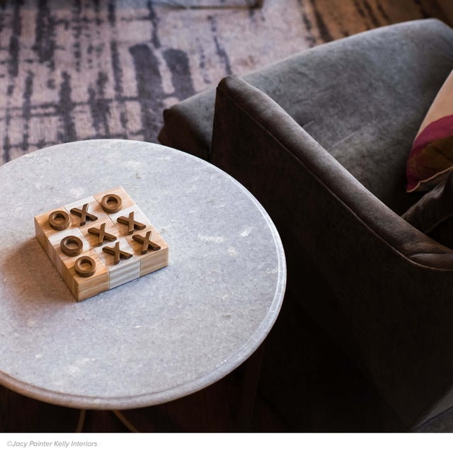 A classic game turned décor. This stylish and functional Tic Tac Toe game is played with brass X’s and O’s on a natural-...