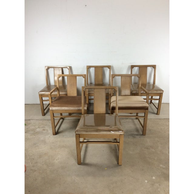 This set of six mid century modern dining chairs features hardwood construction, original limed walnut finish, and vintage...