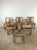 This set of six mid century modern dining chairs features hardwood construction, original limed walnut finish, and vintage...