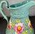 Large antique jug in a lovely blue gray color with a pink floral design and decorative handle. *Former property of the...