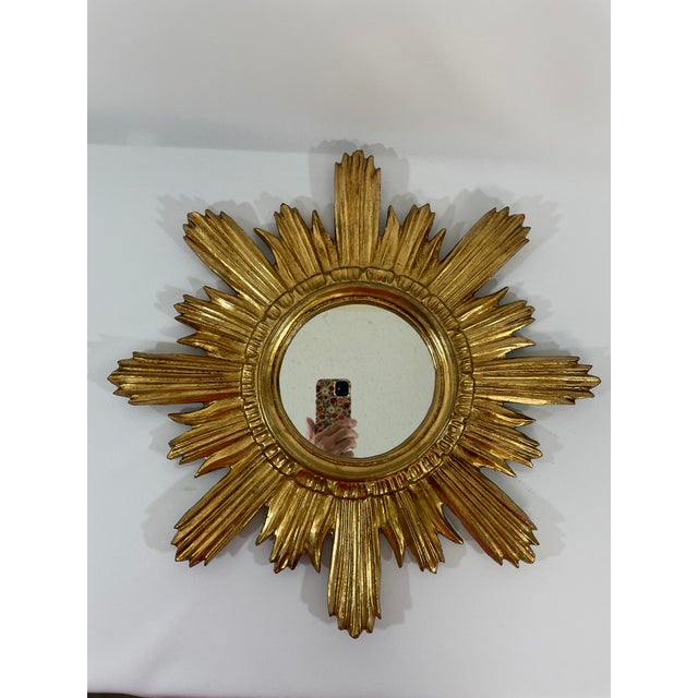 A gorgeous classic 18" Italian Giltwood Sunburst Wall Mirror from the Mid 20th Century. This hand crafted wood and gesso...