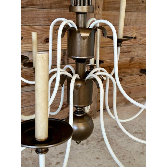 A fabulous vintage twelve-light chandelier featuring a dramatic spray of sculptural brass-tone tole palm leaves above...
