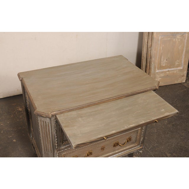 A pair of French design inspired, elaborately carved and painted wood nightstands, with pull-out shelf at top. These...